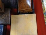 a red chair with a wooden seat and a wooden table with a book on it