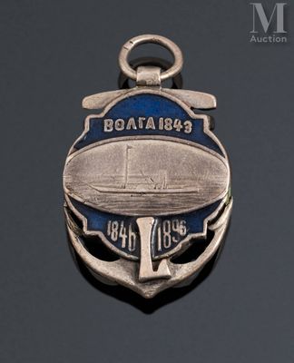 a silver medal with a boat on it on a black surface