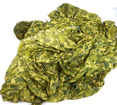 green and yellow camouflage fabric on a white background