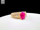 an image of a gold ring with a pink stone surrounded by diamonds