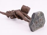 a sculpture of a man laying on a rock