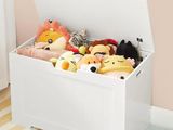 a toy box with stuffed animals in it on the floor