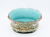 a blue bowl that is sitting on a white surface