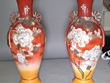 two vases that are sitting on a table