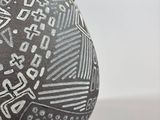 a black and white vase sitting on a table