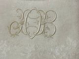 a white towel with a monogram on the front of it