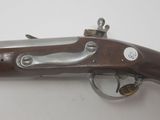 a close up of a gun on a table with a white background