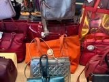 many purses on display on a table in a store
