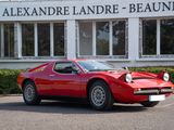 a red sports car parked in front of a building