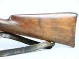 an old rifle with a wooden barrel on a white background