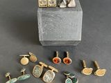several different types of cuff watches and cuff rings on a black surface
