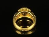 an image of a gold ring on a black surface