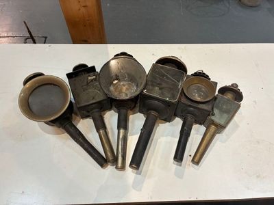 four different types of gas valves on a white table