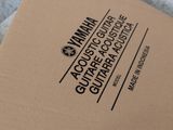 a brown box with a logo on it sitting on a bed