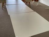 a white table and chairs in a room with a view