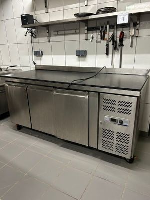 a large kitchen with stainless steel appliances in it