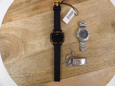 a watch that is sitting on top of a wooden table