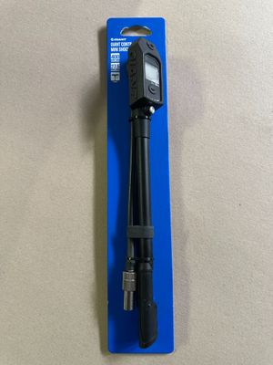 a close up of a pen with a black handle on top of a blue package