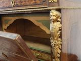 a wooden cabinet that has a door open on it