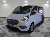 the white van is parked on a checkered floor in a garage