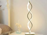 a lamp that is sitting on a table next to a bed