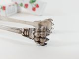 a silver fork with a piece of fruit on it