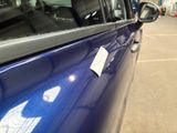 a blue car with a sticker on the side of it