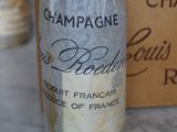a bottle of champagne sitting on a table next to a box