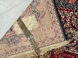 a carpet with a cross on it and a pair of shoes on the floor
