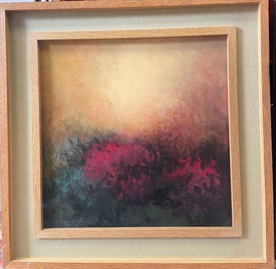 painting of a field of flowers in a wooden frame on a table