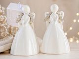 two white angel figurines sitting next to each other