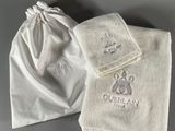 two towels and a bag are sitting on a table