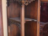 a wooden cabinet with a glass door in a room