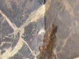 a close up of a marble vase on a table
