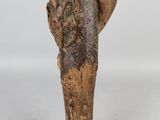 a close up of a wooden sculpture of a bird on a branch