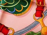 a close up of a colorful scarf with a horse on it