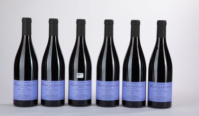 six bottles of wine are lined up in a row on a table