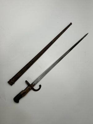 two old swords on a white surface with a black handle