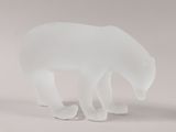 a frosted glass sculpture of a polar bear on a white surface