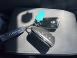 a car key and a cell phone sitting on a seat