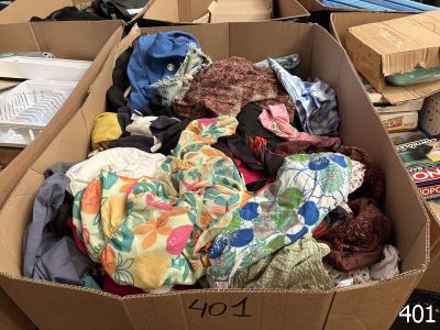 a cardboard box filled with clothes and other items
