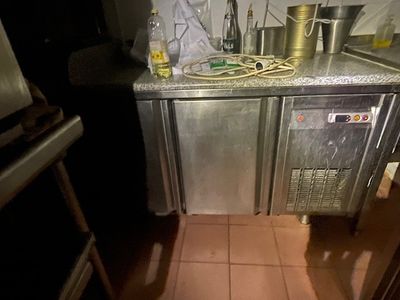an image of a kitchen with a sink and a refrigerator