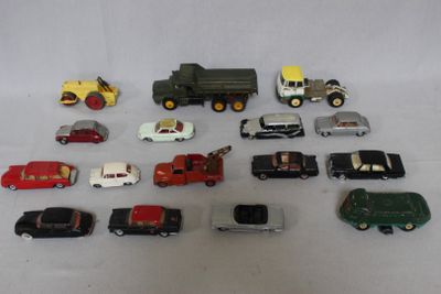 a lot of toy cars and trucks on a white surface