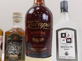 several bottles of liquor are lined up on a table