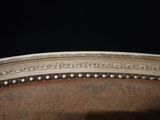 a close up of a chair with pearls on the back of it