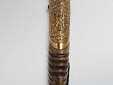 a close up of a wooden stick with a cat head on it