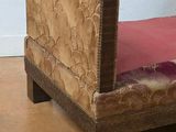 a brown couch with a pink pillow on it