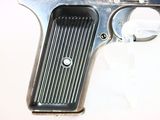 a gun that is sitting on a white surface