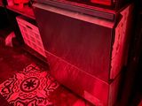 an image of a kitchen with a red light in the dark