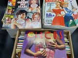 several magazines are stacked on top of each other on a table